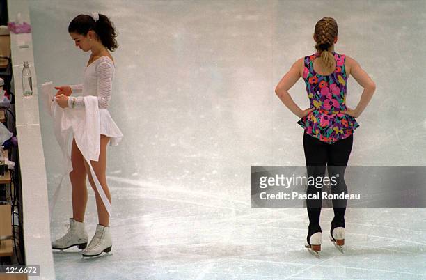 American ice skaters Nancy Kerrigan and Tonya Harding pass each other without notice on the ice rink during a practice session at the 1994...
