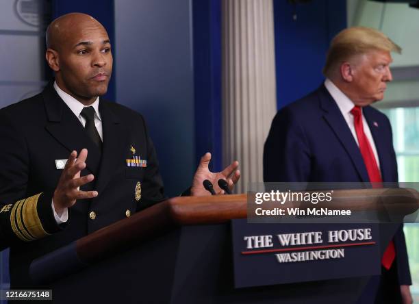 Surgeon General Jerome Adams speaks while flanked by U.S. President Donald Trump during a White House Coronavirus Task Force briefing at the White...