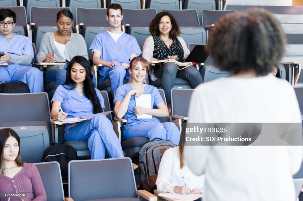 Professor teaches a class of medical students