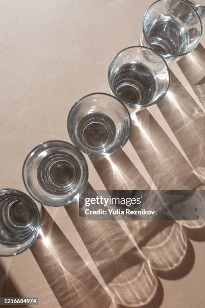 top view of glasses on the brown background - water beaker stock pictures, royalty-free photos & images