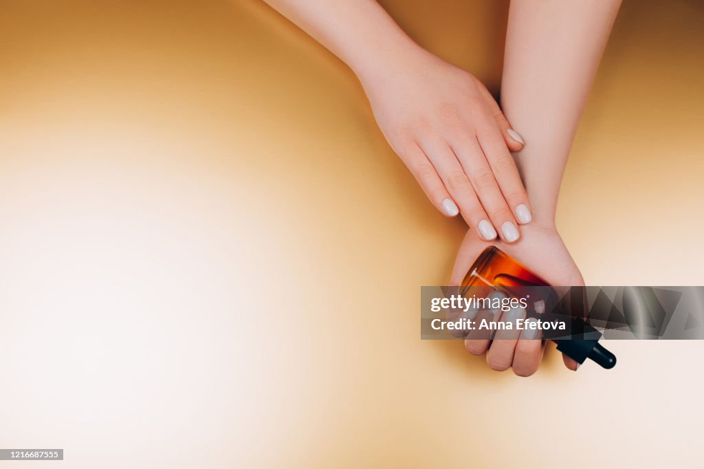 Oil care cosmetics in woman's hands