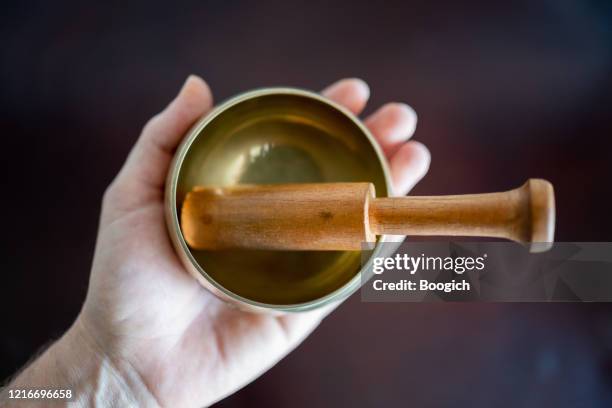 photograph of a woman's hand holding a small sound bowl instrument - epidemic sound stock pictures, royalty-free photos & images