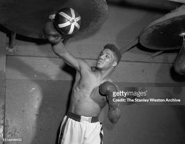 Middleweight professional boxer Rory Calhoun of the United States punches the speed bag on March 28, 1957 at Stillman's Gym in New York, New York.