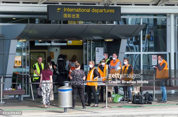 German embassy staff receive German citizens at the departures terminal at Auckland International Airport on April 04, 2020 in Auckland, New Zealand....
