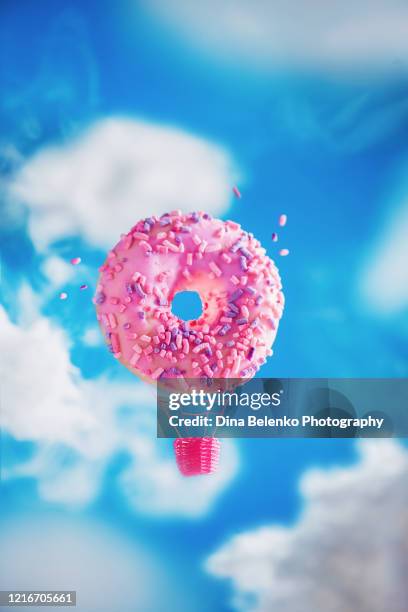 donut hot air balloon, pink donut in the clouds, creative food photography - donut stock pictures, royalty-free photos & images