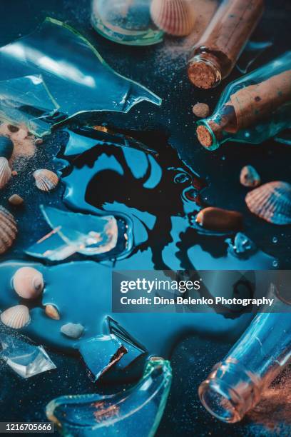 broken bottle with a reflection of tentacles, creative travel still life - kraken bildbanksfoton och bilder