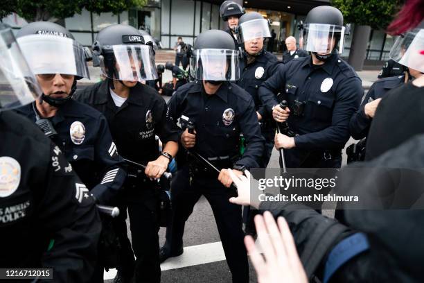 Law enforcement push forward moving protesters in the Fairfax District on Saturday, May 30, 2020 in Los Angeles, CA. Protests erupted across the...