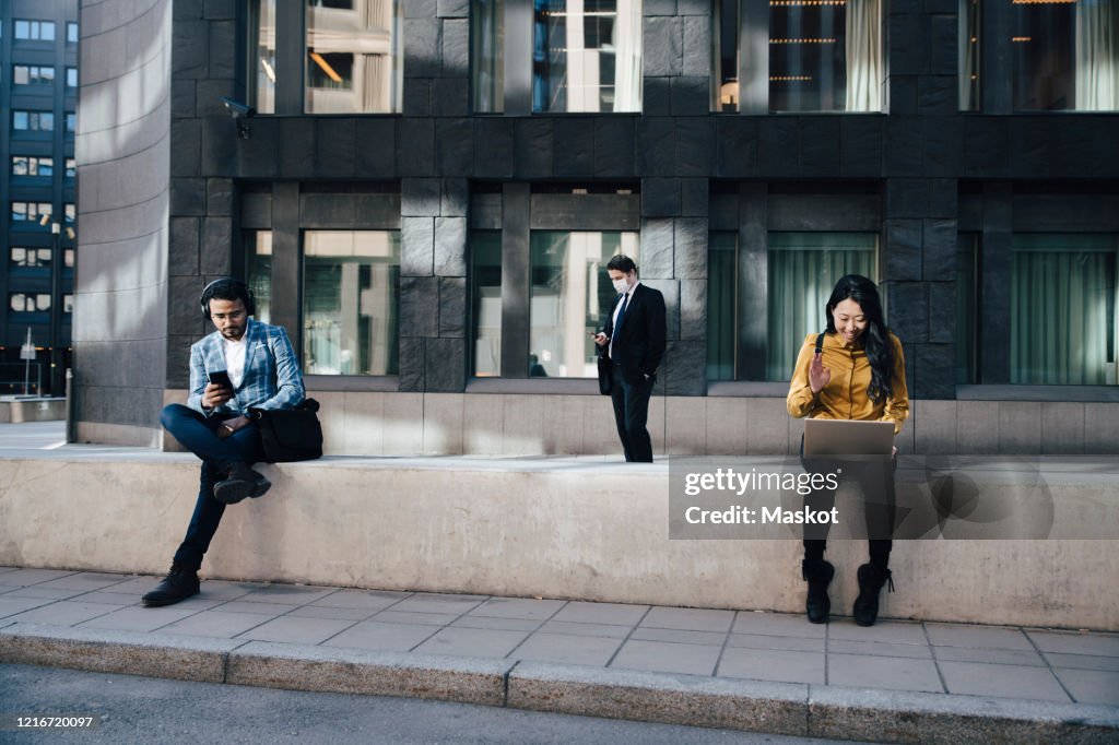 Social distancing business people woking outdoors