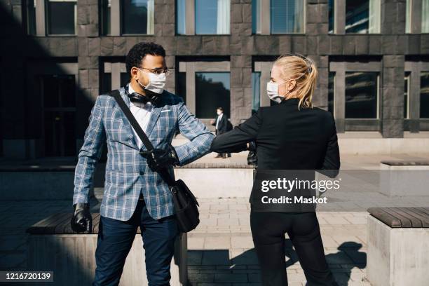 business people using elbow greeting during covid-19 pandemic - social distancing work stock pictures, royalty-free photos & images