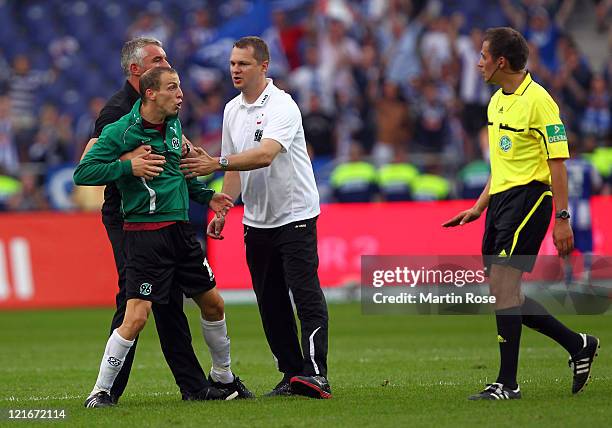 Jan Schlaudraff of Hannover argues with referee Robert Hartmann during the Bundesliga match between Hannover 96 and Hertha BSC Berlin at AWD Arena on...