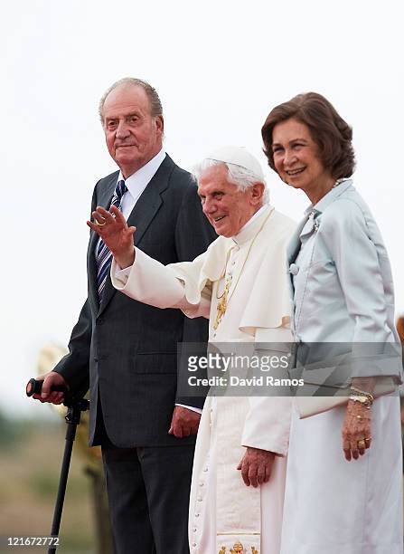 Pope Benedict XVI waves to the crowd surrounded by Queen Sofia of Spain and King Juan Carlos of Spain at the end of his visit to Spain for leading...