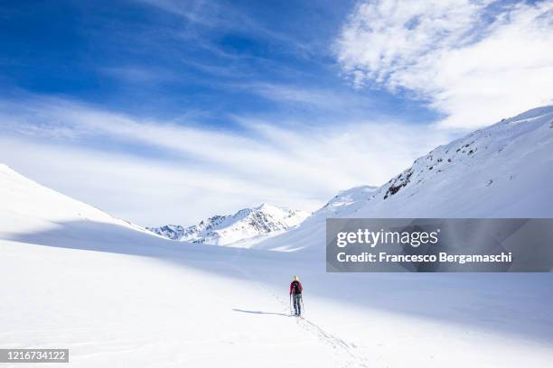 single ski tourist walk with ski in the fresh snow. - engadin stock pictures, royalty-free photos & images