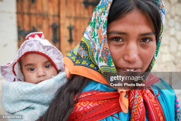 a young tarahumara mother in traditional clothing in the town of creel in the state of chihuahua in mexico - tarahumara stock pictures, royalty-free photos & images