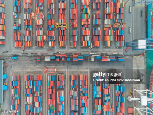 aerial top view container ship crane lifting container for logistic by sea in warehouse. - shipping container top view - fotografias e filmes do acervo