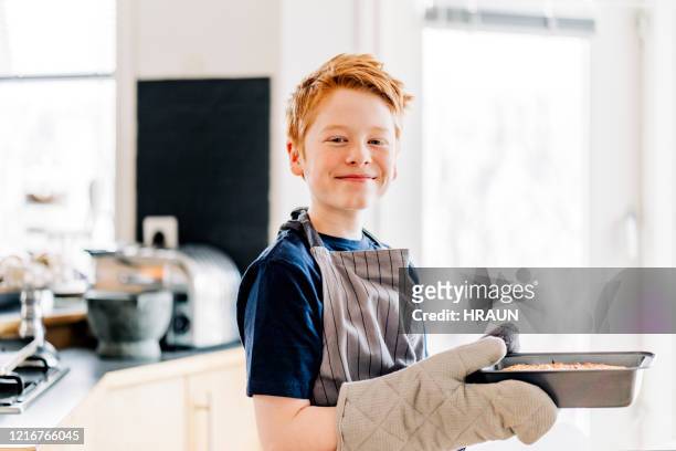 young boy baking bread at home - quarantine cooking stock pictures, royalty-free photos & images