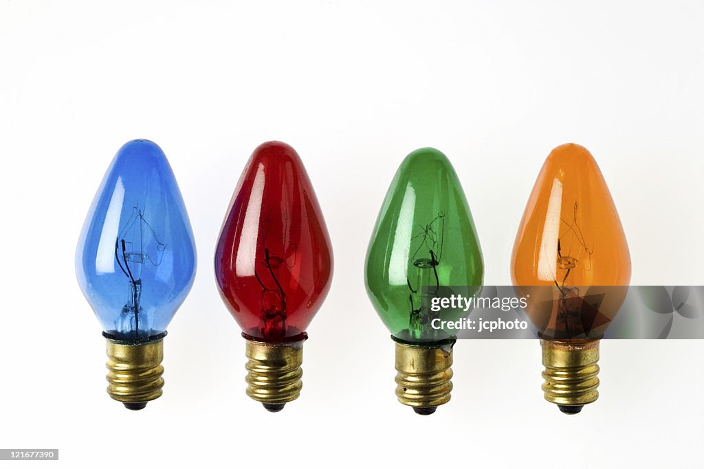Four primary colored Christmas light bulbs in a row