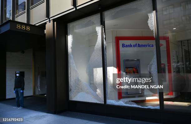 Broken window of a bank is seen on H Street, near the White House following riots in Washington, DC on June 1, 2020. - Police fired tear gas outside...
