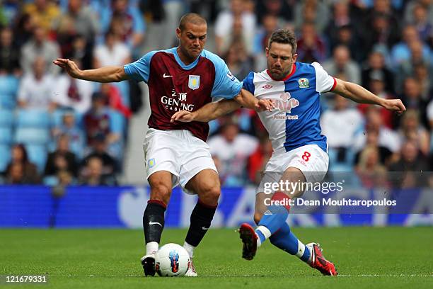 Luke Young of Aston Villa and David Dunn of Blackburn battle for the ball during the Barclays Premier League match between Aston Villa and Blackburn...