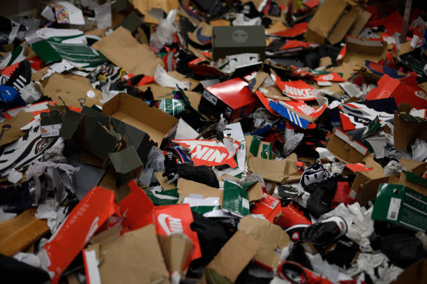 Empty shoe boxes are left on the ground in the storage room of a sneaker store after looters vandalized several business overnight, in the Mt...