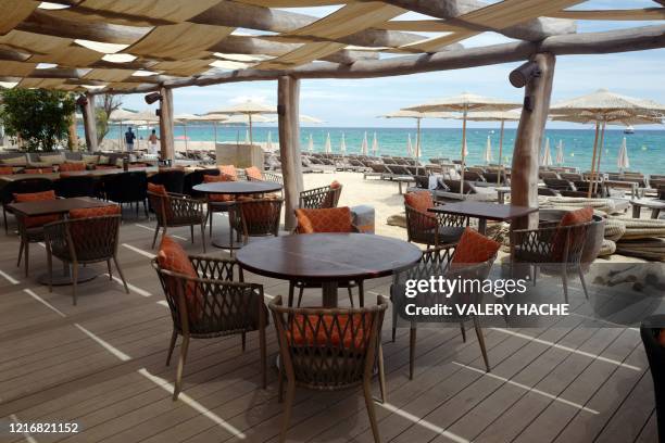 Employees prepare the terrace of a restaurant on the beach of the French Riviera city of Ramatuelle, southern France, on June 1 as France eases...