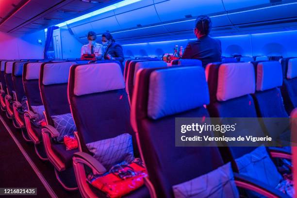 Air France staff wear face masks on a flight from Paris to Sao Paulo, Brazil, on May 23, 2020. The flight was mainly designated for the repatriation...