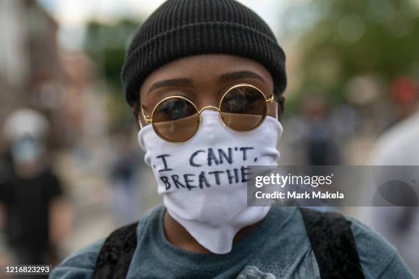Protester marches with a cloth mask stating "I CAN'T BREATHE" in the aftermath of widespread unrest following the death of George Floyd on June 1,...