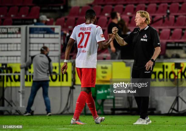 Anthony Modeste bumps fist with his manager Markus Gisdol of Koeln during the Bundesliga match between 1. FC Koeln and RB Leipzig at...