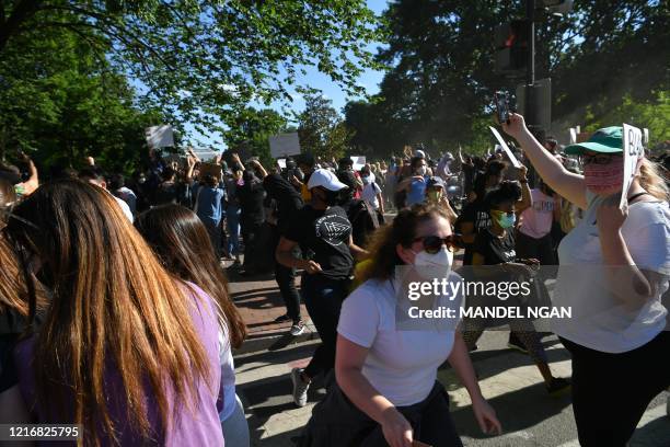 Protestors march on Lafayette Square near the White House in Washington, DC on June 1, 2020. - Police fired tear gas outside the White House late...