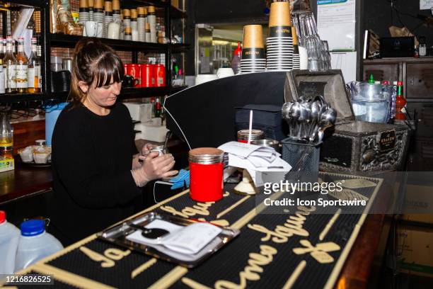 Barista at LaRoche prepares coffee as they reopen their doors to customers for the first time in three months as COVID-19 restrictions ease today...