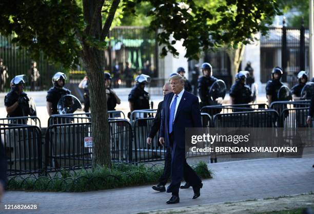 President Donald Trump walks back to the White House after spending time in front of St. John's Episcopal church in Washington, DC on June 1, 2020 as...