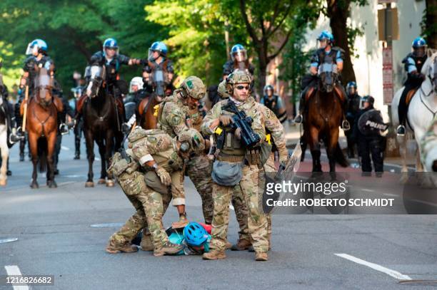 Marshals are restraining a protestor near the White House on June 1, 2020 as demonstrations against George Floyd's death continue. - Police fired...