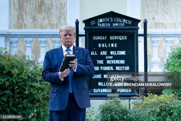 President Donald Trump holds a Bible while visiting St. John's Church across from the White House after the area was cleared of people protesting the...
