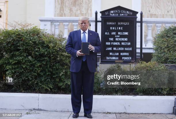 President Donald Trump poses with a bible outside St. John's Episcopal Church after a news conference in the Rose Garden of the White House in...