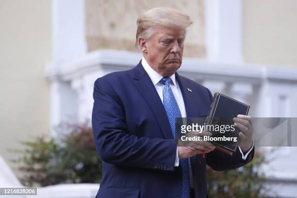 President Donald Trump poses with a bible outside St. John's Episcopal Church after a news conference in the Rose Garden of the White House in...