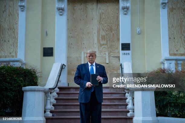 President Donald Trump holds a Bible while visiting St. John's Church across from the White House after the area was cleared of people protesting the...
