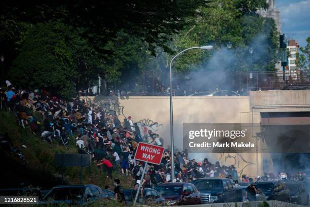 Protesters race up a hill after being shot by tear gas after a march through Center City on June 1, 2020 in Philadelphia, Pennsylvania....