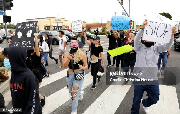 Demonstrators march in the streets in a peaceful protest in Cerritos on Monday, June 1, 2020.