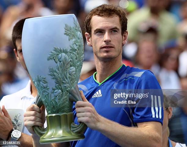 Andy Murray of Great Britain holds up his championship trophy after he defeated Novak Djokovic of Serbia during the Western & Southern Open at the...