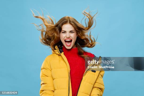 joyful young woman with red hair in warm winter clothes laughing fun - jacket stock pictures, royalty-free photos & images