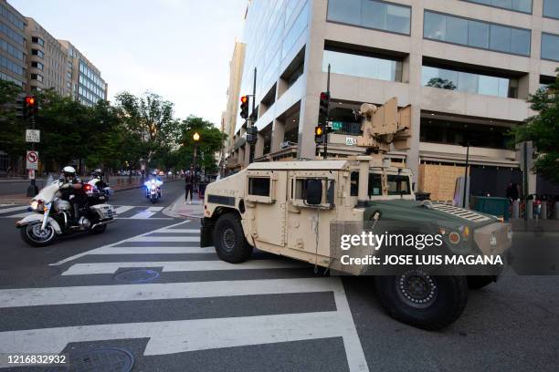 Military police Humvee blocks the street in downtown as demonstrators protest during a protest over the death of George Floyd in Washington D.C. On...