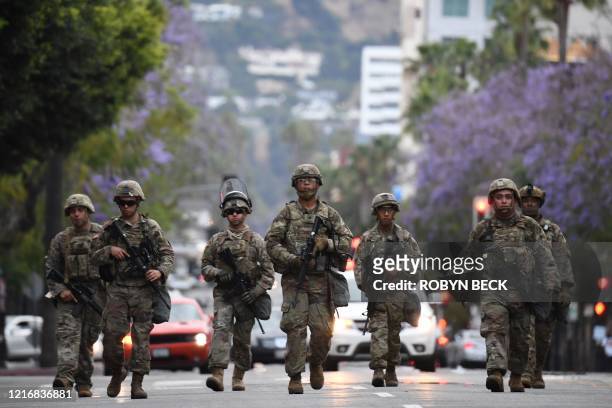 Armed National Guard soldiers patrol on Hollywood Blvd, June 1, 2020 in Hollywood, California as peaceful protests and looting continue in Los...