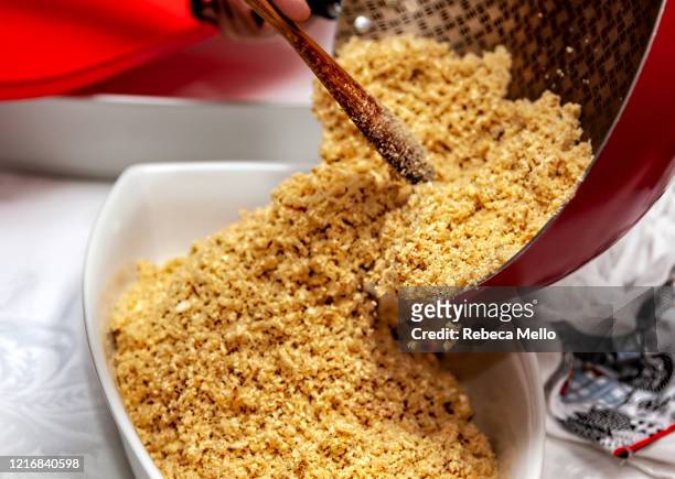 pouring the ready-made farofa in the dish - tapioca stock pictures, royalty-free photos & images