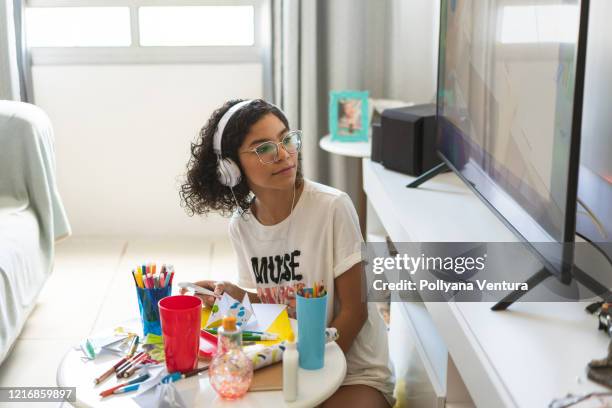 teen girl watching digital tv in the living room - brazil girls supporters stock pictures, royalty-free photos & images