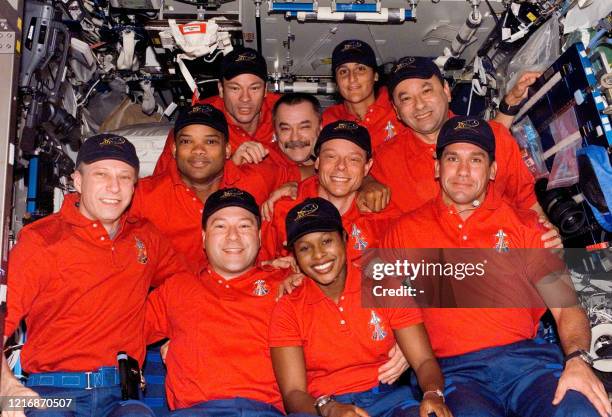 The STS-116 and Expedition 14 crewmembers gather for a group portrait during a joint crew press conference in the Destiny laboratory of the...