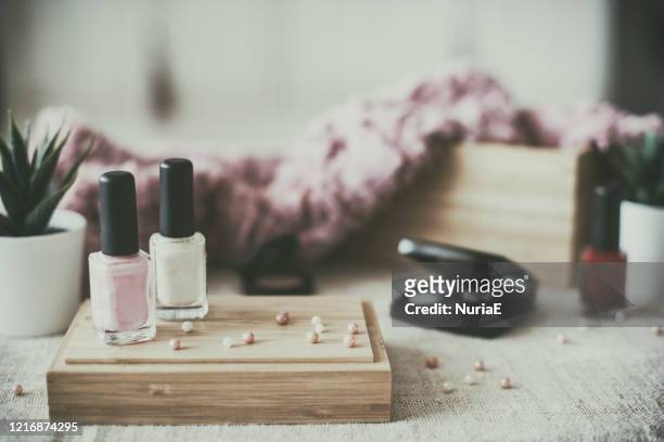 close-up of nail varnish and cosmetics on a table - vanity stock pictures, royalty-free photos & images