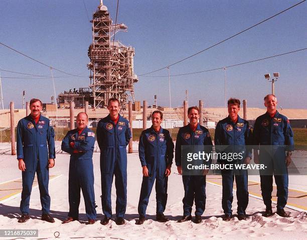 Space shuttle Discovery crew members pose for a photo 16 November 1999 during a meeting with the media at Kennedy Space Center's Launch Pad 39-B. The...