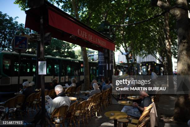 Customers have a drink on a terrace of the Cafe de la Mairie on Place Saint-Sulpice a cafe in Paris on June 2 as cafes and restaurants reopen in...