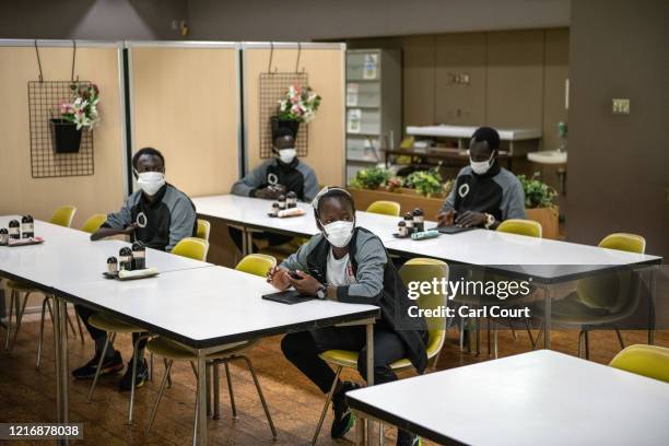 Members of the South Sudanese Olympic team socially distance as they prepare to eat lunch at a canteen in Maebashi City Hall on June 2, 2020 in...
