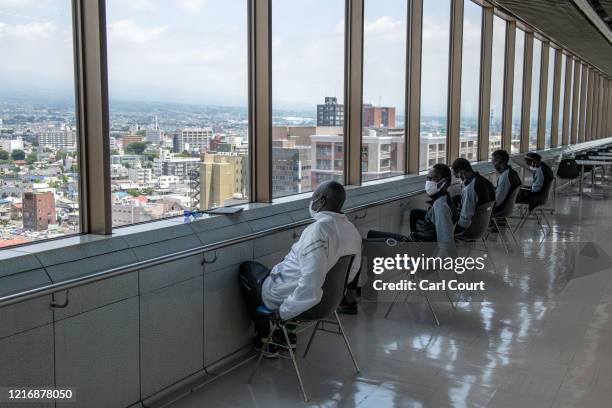 Members of the South Sudanese Olympic team chat as they enjoy the view from Maebashi City Hall on June 2, 2020 in Maebashi, Gunma, Japan. The four...