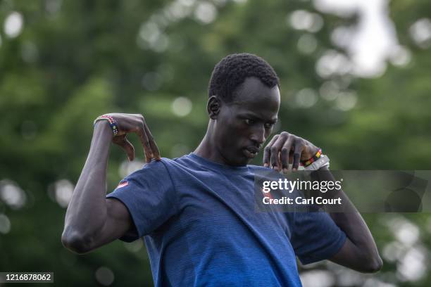 Year-old South Sudanese 1500m runner Abraham Majok Matet Guem warms up as he prepares to train at an athletics track on June 2, 2020 in Maebashi,...